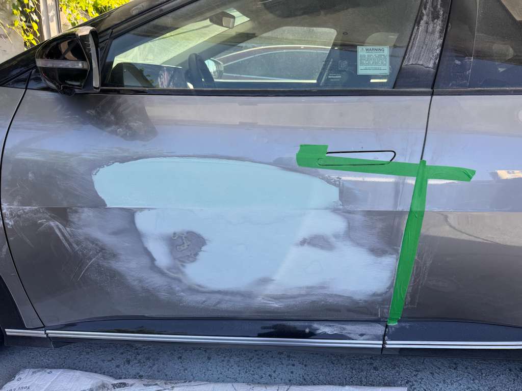 Door panel sanded and feathered down to bare metal and primer, ready for paint